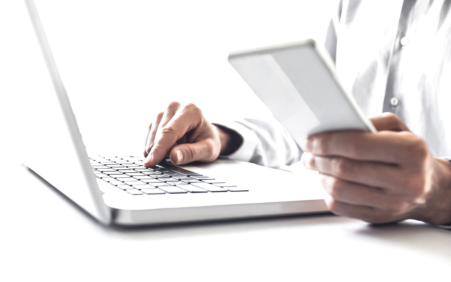 hands typing on a laptop